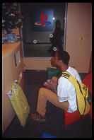 Darryl Jones passing time playing video games at the Tokyo airport