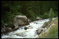 David Benson traversing the river via a tyrollean traverse. Boulder Canyon, Colorado
