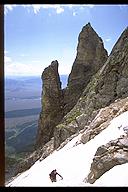 Ian Springsteel hiking past the Idol and the Worshiper on Teewinot, Grant Teton NP, Wyoming